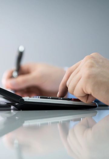 Person tapping on a calculator